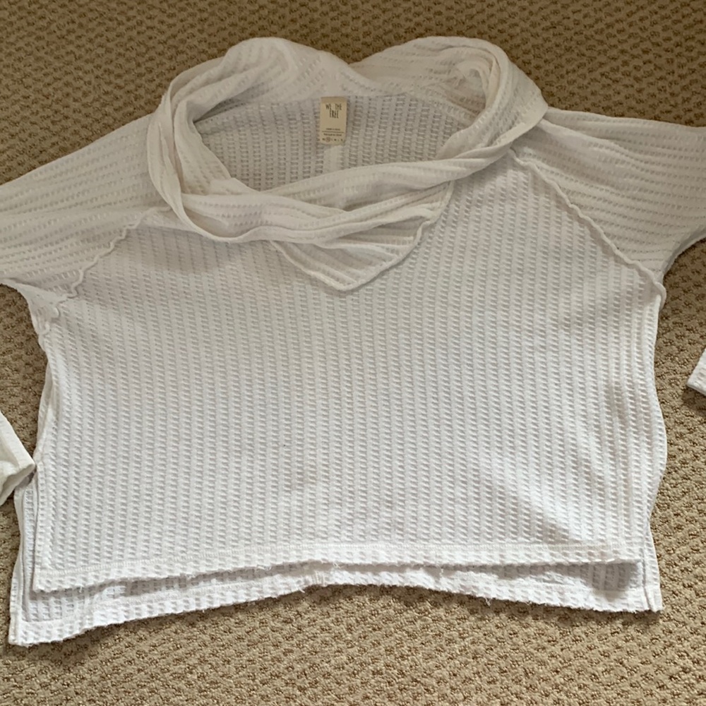 This is a sweater from Free People. It is white and a XS.